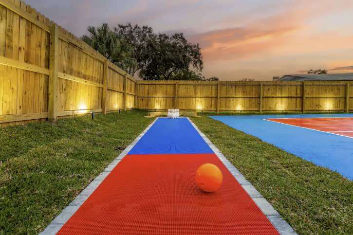 Outdoor court with red and blue playing surface, and orange ball.